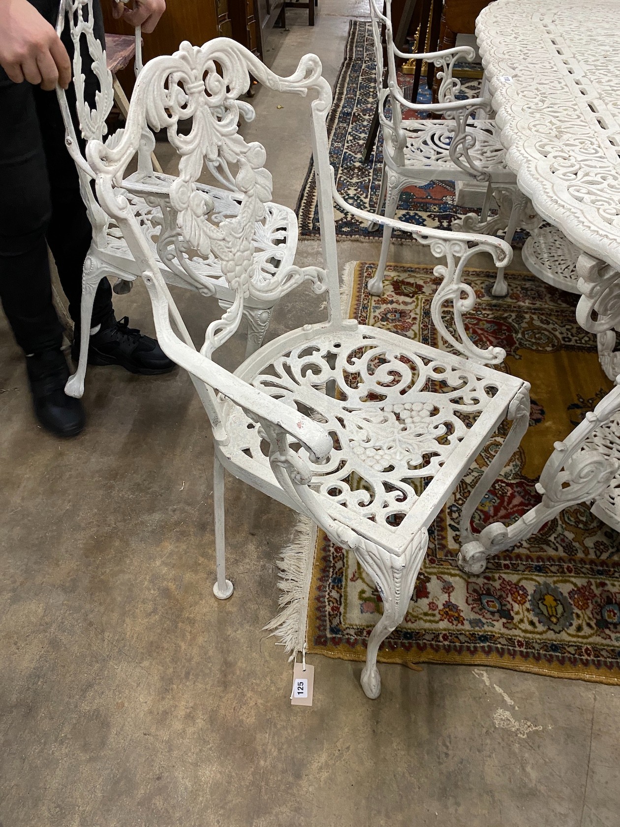 A Victorian style painted cast aluminium garden table, length 180cm, width 90cm, height 72cm and four matching elbow chairs